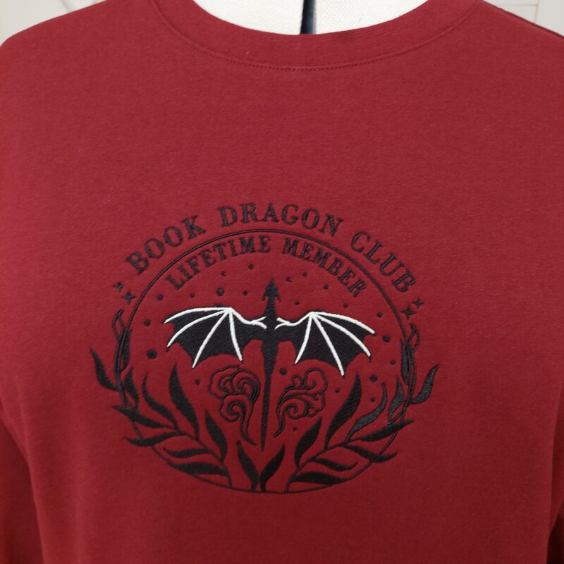 Cozy sweatshirts featuring the phrase "Book Dragon Club Lifetime member " prominently displayed on the chest. Perfect for book lovers!